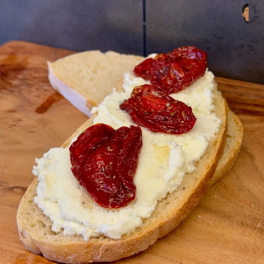 Sun-dried tomatoes on a sour dough slice with cream cheese. Easy healthy sandwich 